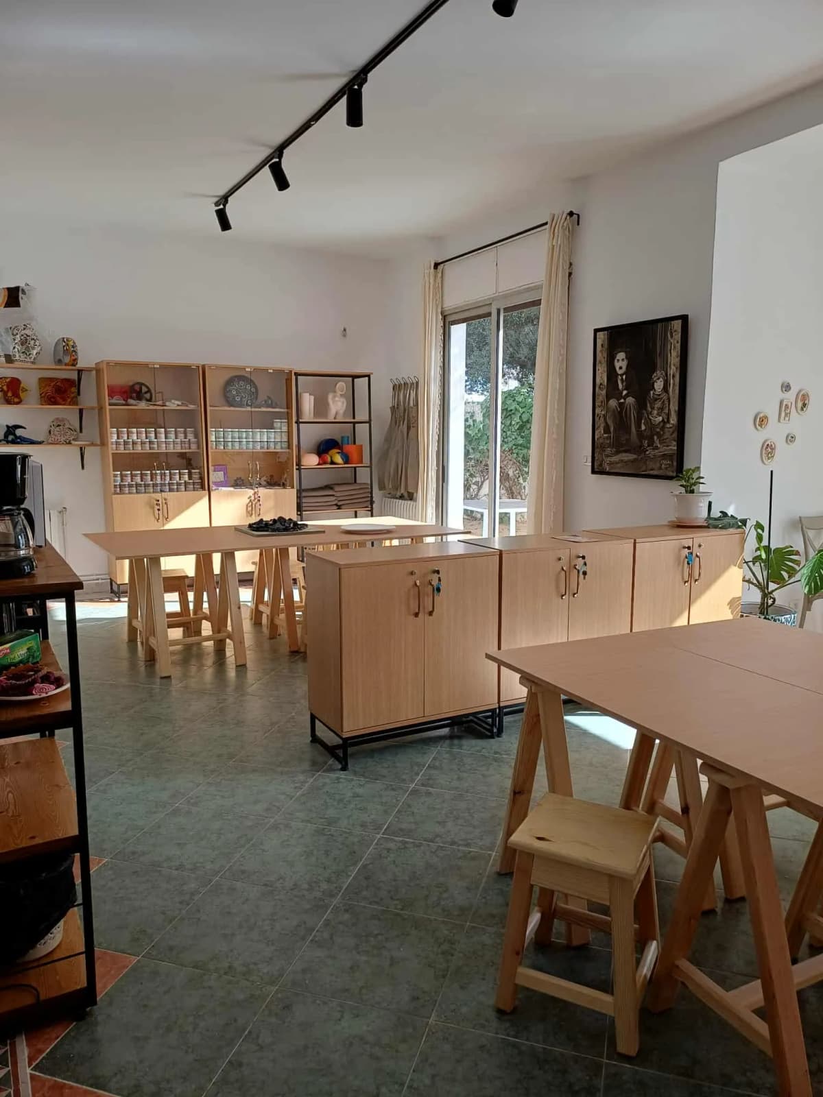 Atelier principal Lik'Art avec tables en bois, rangements de matériel et lumière naturelle